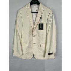 This Lauren Ralph Lauren Boy's Suit Blazer In Size 14r Is A Perfect Addition To Your Kid's Wardrobe. The Blazer Has A Solid Pattern With A White Color That Makes It Suitable For Casual Occasions. It Has Long Sleeves And A Regular Jacket/Coat Length. The Blazer Is Made Of A Blended Fabric Of Polyester And Rayon And Is Dry Clean Only. The Blazer Has A Single-Breasted Cut With A Two-Button Jacket Front Button Style. It Has A Tuxedo Style With Lined And Inner Pockets. The Blazer Comes In A Set That Casual Slim Fit Spring Blazer, Classic Slim Fit Spring Outerwear, Spring Slim Fit Blazer With Pockets, Tailored Casual Spring Suits, Casual Tailored Spring Suits, Casual Fitted Solid Suits, Classic Slim Fit Spring Blazer, White Cotton Sport Coat With Pockets, Spring Slim Fit Single Breasted Sport Coat