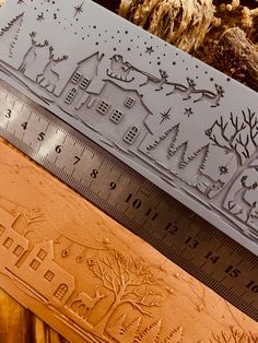 three different types of wooden rulers on top of each other with trees and houses in the background