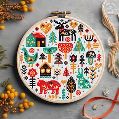 a cross stitch pattern with animals and trees