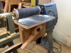 a machine that is sitting in the middle of a workbench with tools on it