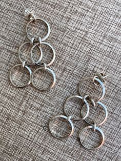 "Sterling silver (tested) Modernist and unusual design Dangling hoops Substantial on but light Each earrings weighs 8 grams Stamp: none Condition: Excellent condition. Nice patina. We've not polished them, leaving that to new owner as desired. See pics. Sold as is. Measurements: 1 x 2.5\" (2.54 x 6.35cm) Materials: sterling silver Provenance: early1990s Care: polish with soft cloth, as desired. Check measurements and/or convo with ANY questions prior to purchase as there are no returns. 20240113J5003" Modern Silver Hoop Clip-on Earrings, Modern Silver Small Hoop Clip-on Earrings, Modern Metal Clip-on Earrings For Anniversary, Fashion Scrapbook, Antique Pictures, Precious Jewels, Picture Hangers, Unusual Design, Modern Earrings