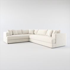 a white sectional couch sitting on top of a white floor