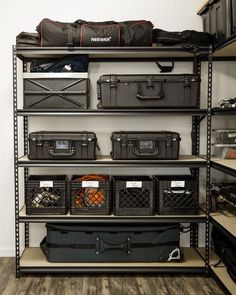 the shelves are filled with many different types of storage boxes and other items in black bins