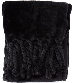 a black blanket with fringes on it