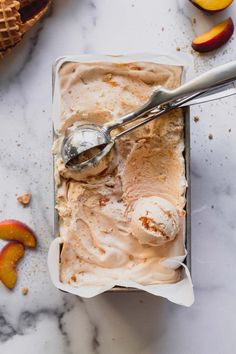 an ice cream dish with peaches on the side