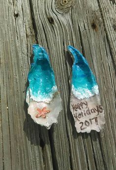 two pieces of glass sitting on top of a wooden table next to a sign that says happy birthday