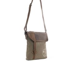 This bag hearkens to exotic adventures and a great style you'll love! Sandstone upcycled woven military canvas and caramel leather merge perfectly. Special overprinting hearkens to travel abroad, while an extra zippered pockets on the back adds convenience. The durable shoulder strap is in matching leather. More Information Materials Canvas & Leather Item Width 12.5 Item Depth 2.5 Item Height 11.5 Shoulder 22 Khaki Canvas Travel Bag With Adjustable Strap, Khaki Canvas Bag With Adjustable Strap For Travel, Brown Duck Canvas Shoulder Bag With Adjustable Strap, Brown Coated Canvas Bag With Adjustable Strap, Khaki Canvas Shoulder Bag With Leather Trim, Brown Shoulder Bag With Leather Patch For Outdoor, Brown Shoulder Bag With Adjustable Strap For Adventure, Brown Coated Canvas Crossbody Bag, Casual Brown Coated Canvas Satchel