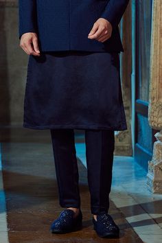 Navy blue textured bandhgala with band collar and geometric embroidery. Comes with kurta and pant.
Component: 3
Pattern: Embroidery
Type Of Work: Geometric
Neckline: Bandhgala: Band Collar
Sleeve Type: Bandhgala: Full sleeves
Fabric: Bandhgala: Textured fabric, Kurta and Pant: Linen Satin
Color: Blue
Other Details: 
Geometric embroidery
Occasion: Sangeet - Aza Fashions Silk Kurta For Formal Festivals, Formal Silk Kurta For Festivals, Blue Traditional Wear With Zari Work For Semi-formal Events, Semi-formal Blue Traditional Wear With Zari Work, Blue Semi-formal Traditional Wear With Zari Work, Traditional Blue Sets For Semi-formal Occasions, Semi-formal Traditional Blue Wear, Traditional Formal Full-length Sets, Traditional Formal Full Length Sets