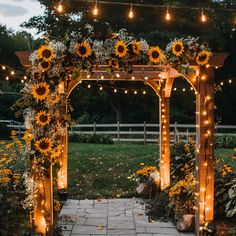 an outdoor wedding ceremony with sunflowers and string lights on the arbor, surrounded by greenery