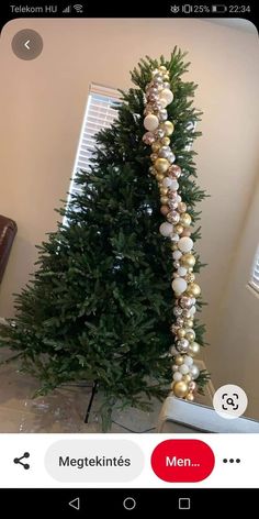 a christmas tree decorated with gold and white ornaments