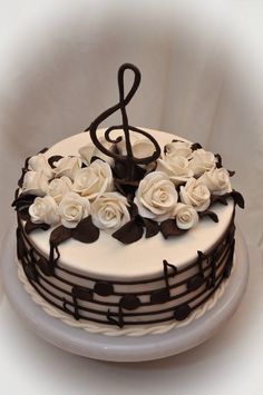 a cake decorated with music notes and white roses