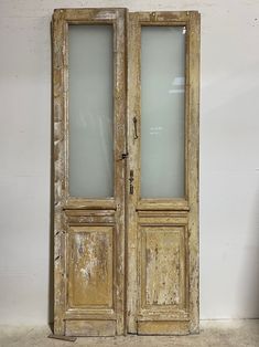 an old wooden double door with frosted glass