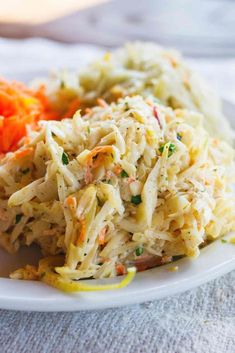 a white plate topped with coleslaw and carrots