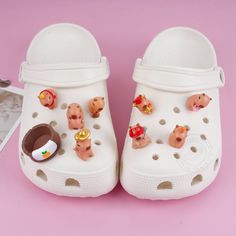 a pair of white shoes with pigs on them and other toys in the bottom part