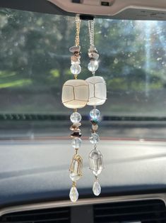 the inside of a car with beads hanging from it