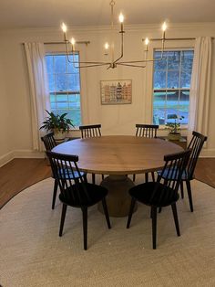 a dining room table with four chairs around it