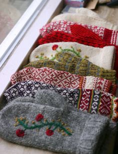 several sweaters are lined up on a window sill