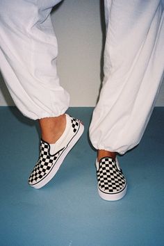 You'll reach for the Vans Classic Black & White Checkerboard Slip-On Sneakers time and time again when you want to create casually cool looks! These timeless sneakers have a sturdy canvas construction that creates a sleek silhouette with a rounded toe upper, elastic gussets at the sides, and a low-cut, padded collar. The effortless slip-on design makes these shoes essential when you have places to go and things to do! Logo tag at the outstep and heel. Iconic black & white checker design. 1" rubber sole. Lightly cushioned insole. Rubber sole has nonskid markings. Man made materials. Imported. Lulus | Classic Black & White Checkerboard Slip-On Sneakers | Size 7.5. Shoes Essential, Timeless Sneakers, Vans Classic Black, Checkered Shoes, Cool Looks, Checkered Vans, Checker Design, Logo Tag, Vans Classic