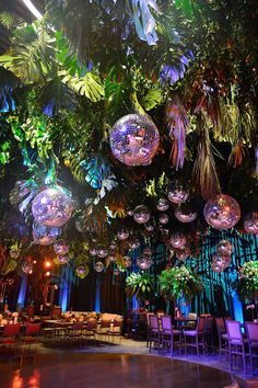 a large room filled with lots of lights and hanging disco balls above the dance floor