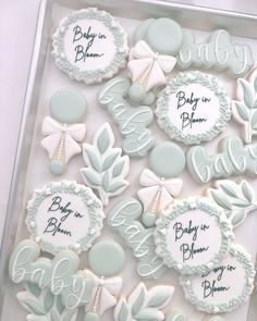 baby in blue and white decorated cookies are on a tray with the words baby in bloom