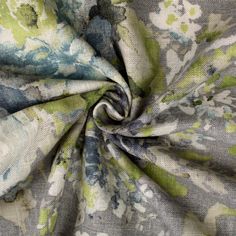 the fabric is very colorful and has many flowers on it, as well as blue and green