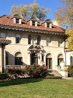 a large house with many windows in the front yard