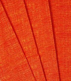 four orange fabric sheets folded together on top of each other, with the same color as the background