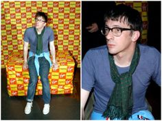 a man wearing glasses and a tie sitting on a chair next to a photo of him