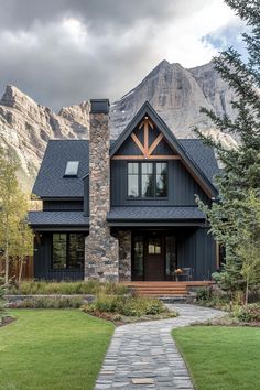 a house with a stone pathway leading to it and mountains in the backround