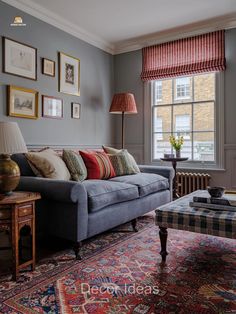 a living room filled with furniture and pictures on the wall