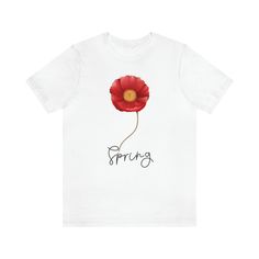 a white t - shirt with a red flower and the word spring written on it