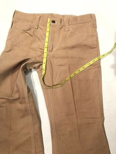 a pair of brown pants with a measuring tape on them