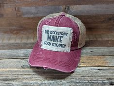 Bad Decisions Make Good Stories is a Funny Hat For Women. These Distressed Ponytail Hat are perfect for a vacation or Girls Trip Gift or a great Friend Gift. Tattered Ponytail Hat 20% Cotton 80% Polyester Double Fabric Brim 7 Panel Hat Patches have frayed edges and are printed with permanent ink. They are adhered to the hat with an iron and strong double sided interfacing. While I do my very best to photograph items to see their true color, due to the nature of electronic devices sometimes color Distressed Adjustable Flat Brim Hat, Distressed Flat Brim Hat With Adjustable Fit, Adjustable Distressed Trucker Baseball Cap, Adjustable Distressed Trucker Hat Baseball Cap, Adjustable Distressed Baseball Cap, Trendy Distressed Adjustable Hat, Trendy Adjustable Distressed Hat, Distressed Curved Brim Hat, Distressed Snapback Baseball Cap