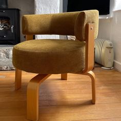 a chair sitting on top of a hard wood floor in front of a fire place