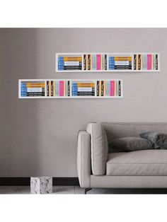 two bookshelves on the wall above a couch