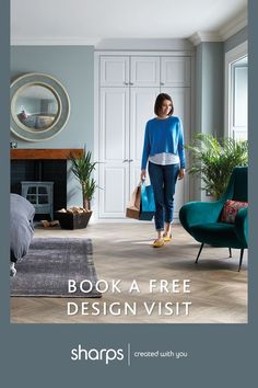 a woman walking through a living room filled with furniture