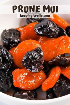 a white bowl filled with raisins and carrots next to the words prune mui