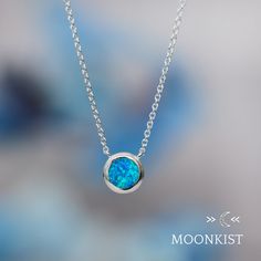 This minimalist necklace is wonderful for anyone with an October birthday! It works beautifully as a delicate layering necklace or an elegant solitaire pendant. Great for everyday wear, this man made blue opal pendant features a 8 mm round cabochon, hand set in a sterling silver bezel mountings. These mountings are firmly soldered and tumble polished for hours to increase durability. This necklace comes complete with a sterling silver chain measuring 16 inches in length, with an additional 2 inc Minimalist Blue Necklace For Anniversary, Blue Minimalist Sterling Silver Necklace, Minimalist Blue Sterling Silver Necklace, Blue Sterling Silver Necklace With Delicate Chain, Minimalist Blue Birthstone Necklace For Gift, Blue Minimalist Birthstone Necklace, Blue Sterling Silver Birthstone Necklace With Round Pendant, Sterling Silver Solitaire Gemstone Necklace, Minimalist Silver Solitaire Gemstone Necklace