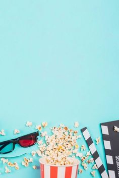 popcorn, sunglasses and movie claps on a blue background