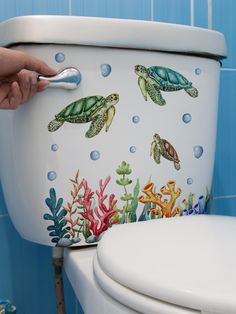 a toilet with sea turtles painted on it