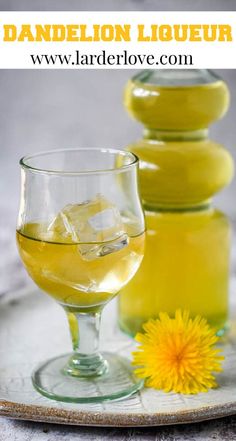 a glass filled with yellow liquid next to a bottle of lemonade and a dandelion flower