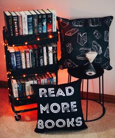 two bookshelves with black and white pillows sitting next to each other