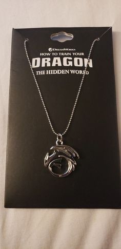 a book with a necklace in the shape of a dolphin on it's cover