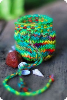 there is a yarn ball and some beads on the table