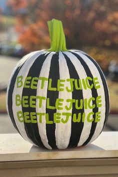 a black and white striped pumpkin sitting on top of a table