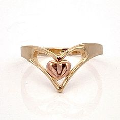 V ring with Heart - Heart in Chevron Two Toned 14k Gold Ring- 14k Yellow and Rose Gold- Size 4.5- ET1505 Ring Size: 4.5- can be resized Metal Content: Solid 14k Yellow and Rose Gold Measurements: Face Height (North to South): 9mm Height of ring off of finger: 2mm Ring Shank width: tapers to approximately 2mm Weight: 1.45 Grams Stamps: MA 14k Condition: Excellent condition  Each piece is thoroughly examined and refinished as needed by our professional jewelers, tested to guarantee metal content,  graded by our in-house GIA (Gemological Institute of America) Graduate Gemologist, and inspected for quality before being carefully packaged and promptly shipped. Thank you for taking the time to shop with us! We have hundreds of more listings, with more being added every week! From necklaces to br Heart-shaped 14k Rose Gold Anniversary Ring, 14k Rose Gold Heart Ring For Anniversary, 14k Rose Gold Heart-shaped Anniversary Ring, 14k Gold Open Heart Ring For Valentine's Day, 14k Rose Gold Rings For Anniversary On Valentine's Day, 14k Rose Gold Rings For Valentine's Anniversary, Ring With Heart, V Ring, Ring Shank