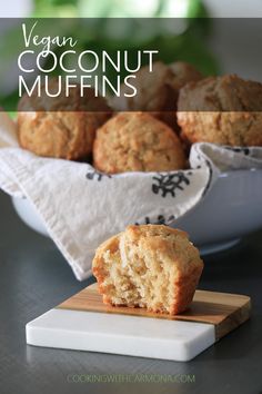 a muffin is cut in half on a cutting board next to some other muffins