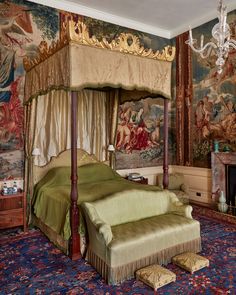 an ornate bedroom with tapestryed wallpaper and canopy bed in the middle of it