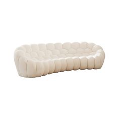 a white couch sitting on top of a white floor