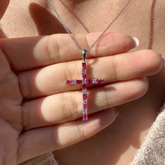 Materials: 14k White Gold Gemstone: Genuine Ruby and Diamond Total Ruby Carat Weight: 0.96 ct. Total Diamond Carat Weight: 0.18 ct. Pendant Diameter: 34.5mm x 18mm Diamond Clarity: SI 1-2 Diamond Color: H color Necklace: Adjustable 16 and 18 inches with a lobster clasp. Chain Weight: 0.6mm .35 grams Description: This listing is for the pendant only, the necklace is not included for the price. However if you would like to purchase the necklace with the pendant, feel free to message me. These are genuine rubies and diamonds, not lab grown. The stones have not been treated in any way. 7 diamonds totaling 0.18 ct and 10 rubies totaling 0.96 ct.  This beautiful piece will not tarnish in the shower and will not irritate the skin. It will arrive in a jewelry box, with a jewelry bag for traveling. Ruby Jewelry With Baguette Diamonds As Gift, Baguette Diamond Cross Pendant Jewelry For Gifts, Aquamarine Studs, Round Sapphire, Sapphire Studs, Color Necklace, Diamond Cross Pendants, Diamond Cross, Diamond Carat